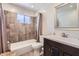 A bathroom with a combination tub and shower and dark wood colored vanity at 3924 E Cortez St, Phoenix, AZ 85028