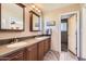 Bathroom with double sinks, wood cabinets, and a view to the toilet room at 3924 E Cortez St, Phoenix, AZ 85028