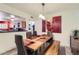 Open dining area with view to the open kitchen features rustic table and modern lighting at 3924 E Cortez St, Phoenix, AZ 85028