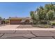 Charming single-story home featuring a two-car garage and a well-maintained front yard with mature trees at 3924 E Cortez St, Phoenix, AZ 85028