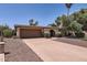 Inviting single-story home with a two-car garage, an arched doorway, and desert landscaping at 3924 E Cortez St, Phoenix, AZ 85028