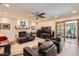 Spacious living room with brick fireplace, ceiling fan, and sliding door access to the sunroom at 3924 E Cortez St, Phoenix, AZ 85028