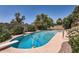 Refreshing swimming pool with diving board surrounded by mature trees, offering a private oasis at 3924 E Cortez St, Phoenix, AZ 85028