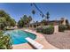 Backyard pool and deck with patio furniture, a diving board, mature plantings, and an expansive patio at 3924 E Cortez St, Phoenix, AZ 85028