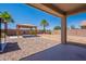Backyard featuring rock landscaping, a covered patio, and a gazebo with a swing at 41251 W Barcelona Dr, Maricopa, AZ 85138