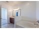 Bathroom view of soaking tub, and vanity with modern fixtures at 41251 W Barcelona Dr, Maricopa, AZ 85138