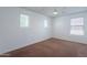 Bright bedroom with neutral carpet, white walls, ceiling fan, and multiple windows allowing natural light at 41251 W Barcelona Dr, Maricopa, AZ 85138