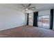 Spacious bedroom with a ceiling fan and sliding glass door offering backyard views at 41251 W Barcelona Dr, Maricopa, AZ 85138