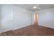 Bedroom with neutral carpet, ceiling fan, and an open door leading to another room at 41251 W Barcelona Dr, Maricopa, AZ 85138