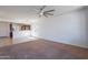 Bright living area showcasing an open floor plan with views of the kitchen and natural light at 41251 W Barcelona Dr, Maricopa, AZ 85138
