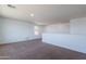 Open loft area with carpet flooring and natural light at 41251 W Barcelona Dr, Maricopa, AZ 85138