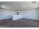 Open loft area with carpet flooring and ample natural light at 41251 W Barcelona Dr, Maricopa, AZ 85138