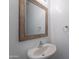 Neat powder room featuring a white vanity sink, framed mirror, and towel ring at 41251 W Barcelona Dr, Maricopa, AZ 85138