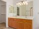 Bathroom vanity featuring double sinks, wood cabinets, and tile flooring at 4143 E Sundance Ave, Gilbert, AZ 85297