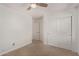 Cozy bedroom features neutral carpet, ceiling fan, and closet space at 4143 E Sundance Ave, Gilbert, AZ 85297