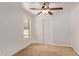 Cozy bedroom featuring neutral paint, carpet, and a window with a view of trees at 4143 E Sundance Ave, Gilbert, AZ 85297