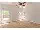 Bright bedroom with neutral carpet, ceiling fan, and multiple windows at 4143 E Sundance Ave, Gilbert, AZ 85297