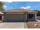 Charming single-story home featuring a tile roof, stone accents, and a two-car garage in a residential neighborhood at 4143 E Sundance Ave, Gilbert, AZ 85297
