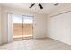 Well-lit bedroom featuring tile flooring, a ceiling fan, and a sliding glass door to the outdoor space at 420 W Yukon Dr # 8, Phoenix, AZ 85027