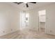 Bedroom features neutral carpeting, a ceiling fan, and entryways to bathroom and closet at 420 W Yukon Dr # 8, Phoenix, AZ 85027