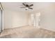 Bedroom featuring neutral carpeting, a ceiling fan, and two entryways to other rooms at 420 W Yukon Dr # 8, Phoenix, AZ 85027
