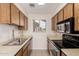 Compact kitchen featuring tiled floors, neutral counters, and essential appliances, maximizing space efficiency at 420 W Yukon Dr # 8, Phoenix, AZ 85027
