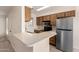 Functional kitchen featuring ample counter space, stainless steel appliances, and wood cabinets for efficient cooking at 420 W Yukon Dr # 8, Phoenix, AZ 85027