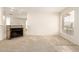 Open living room with a cozy tile fireplace and large window, providing natural light and warmth at 420 W Yukon Dr # 8, Phoenix, AZ 85027