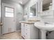Well-lit bathroom features a double sink vanity and access to the outdoors at 4622 E Ellis Cir, Mesa, AZ 85205