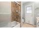 Bathroom features a shower with a safety bar, a white door to outside, and neutral decor at 4622 E Ellis Cir, Mesa, AZ 85205