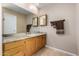 Bright bathroom featuring a large mirror, granite countertops, and a wooden vanity at 4622 E Ellis Cir, Mesa, AZ 85205