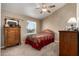 Comfortable bedroom featuring plush carpeting, a ceiling fan, and traditional decor at 4622 E Ellis Cir, Mesa, AZ 85205