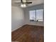 Bright bedroom with wood floors, window with blinds, and neutral walls at 4622 E Ellis Cir, Mesa, AZ 85205
