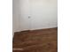 A bedroom with hardwood floor, white walls, and a closed white door at 4622 E Ellis Cir, Mesa, AZ 85205
