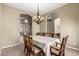 Formal dining room featuring a chandelier and traditional wood furniture at 4622 E Ellis Cir, Mesa, AZ 85205