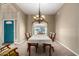 Elegant dining room with chandelier, large window, and comfortable seating at 4622 E Ellis Cir, Mesa, AZ 85205