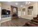 Cozy living room featuring a brick fireplace, wood floors, and comfortable recliners at 4622 E Ellis Cir, Mesa, AZ 85205