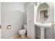 Powder room with pedestal sink, toilet, and storage at 4622 E Ellis Cir, Mesa, AZ 85205