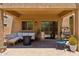 Back patio with cozy seating arrangements, fire pit, desert plants, and sliding glass doors at 4759 E Woburn Ln, Cave Creek, AZ 85331