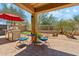 Back patio with outdoor kitchen, grill, seating area with blue cushions, and desert views at 4759 E Woburn Ln, Cave Creek, AZ 85331