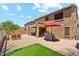 Backyard patio with seating, barbecue, red umbrella, synthetic grass, and desert landscaping at 4759 E Woburn Ln, Cave Creek, AZ 85331