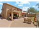 Backyard patio with seating, barbecue, synthetic grass, and desert landscaping at 4759 E Woburn Ln, Cave Creek, AZ 85331