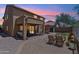 Backyard patio with seating, barbecue, synthetic grass, and desert landscaping at sunset at 4759 E Woburn Ln, Cave Creek, AZ 85331