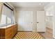 Bright bedroom with a wooden dresser, checkerboard rug, and large closet space at 4759 E Woburn Ln, Cave Creek, AZ 85331