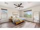 Light-filled bedroom with a queen bed, neutral decor, and wood-look floors at 4759 E Woburn Ln, Cave Creek, AZ 85331