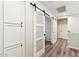 Hallway with white cabinets and a sliding barn door at 4759 E Woburn Ln, Cave Creek, AZ 85331