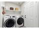 Modern laundry room with front loading washer and dryer and ample storage at 4759 E Woburn Ln, Cave Creek, AZ 85331