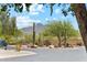 Landscaped roundabout featuring desert plants, rocks, and trees with mountain views at 4759 E Woburn Ln, Cave Creek, AZ 85331