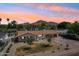 Scenic aerial view of home with a landscaped front yard, three car garage and mountain backdrop at 4920 E Osborn Rd, Phoenix, AZ 85018