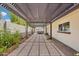 Long covered patio leading to a relaxing hot tub with privacy fencing and desert landscaping at 4920 E Osborn Rd, Phoenix, AZ 85018